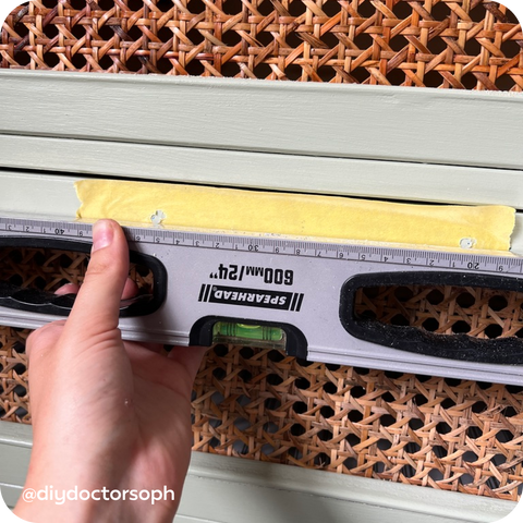 Using masking tape to drill holes in kitchen cabinets