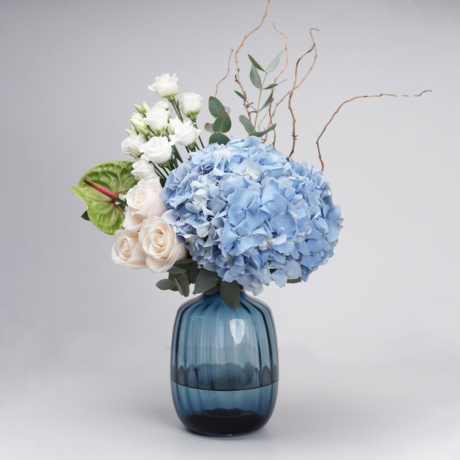 Captivating Mixed Flowers Blue Glass Vase