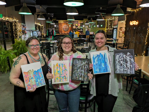 Friends showing their artwork from Art Night at 515 Brewing Company