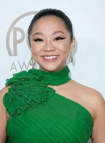 Stephanie Hsu at the PGA Awards in a floor-length green ruffled design gown