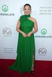 Stephanie Hsu at the PGA Awards red carpet in a floor-length green gown