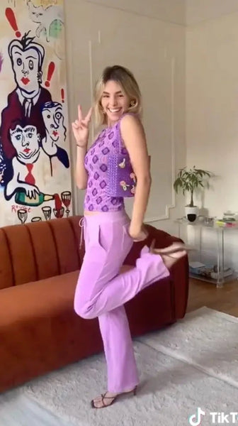 Taylor Quitara wearing purple printed sleeveless top and Y2K Juicy Couture pants