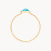 An elegant gold ring featuring a vibrant turquoise gemstone encased in a smooth, raised bezel setting, displayed against a plain white background. The turquoise mini mood ring - 10k yellow gold, turquoise by bluboho has a thin, smooth gold band.