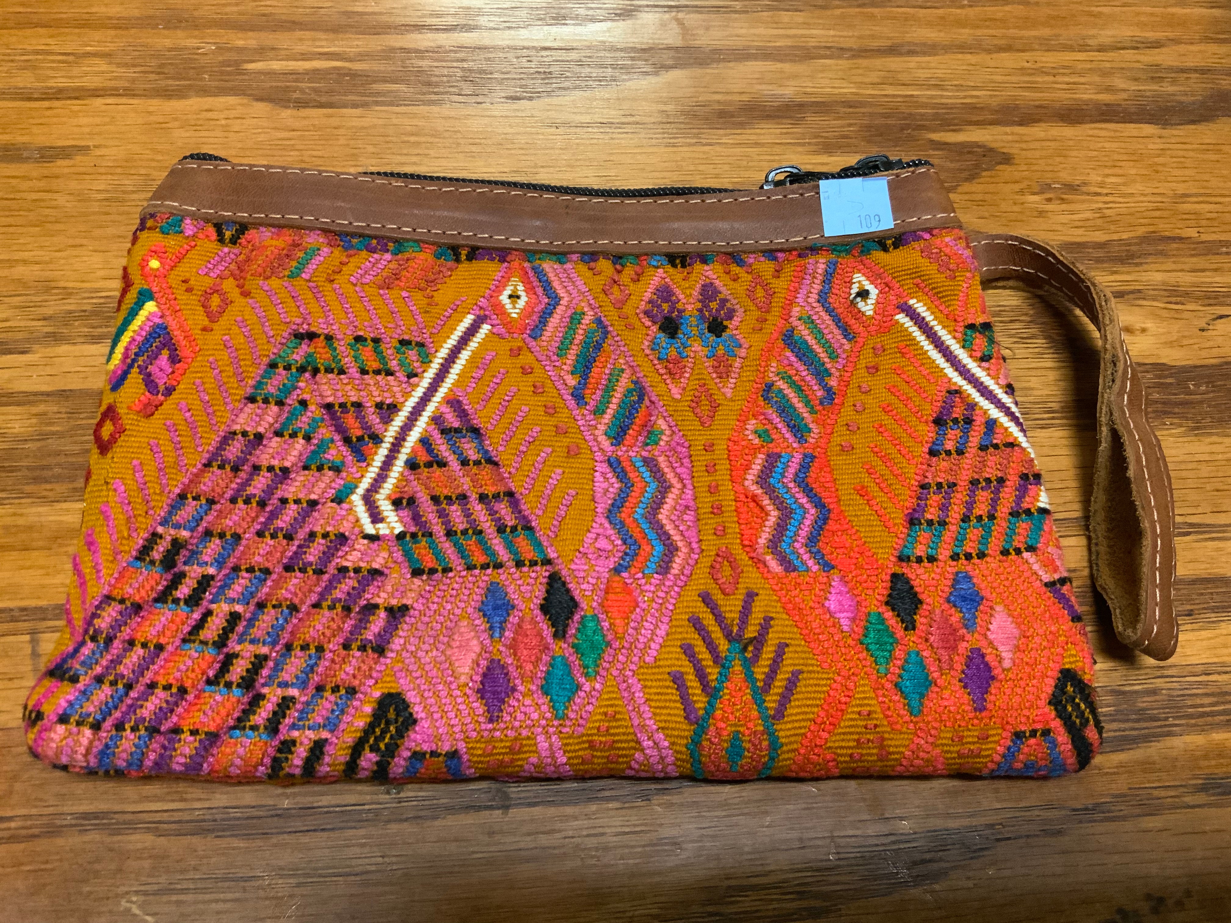 Handwoven vintage fabric wristlet bag with leather. 9” x 6”.