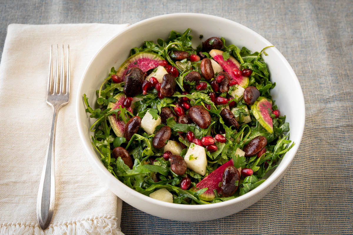 Salad with runner beans, greens, radish, and pomegranate