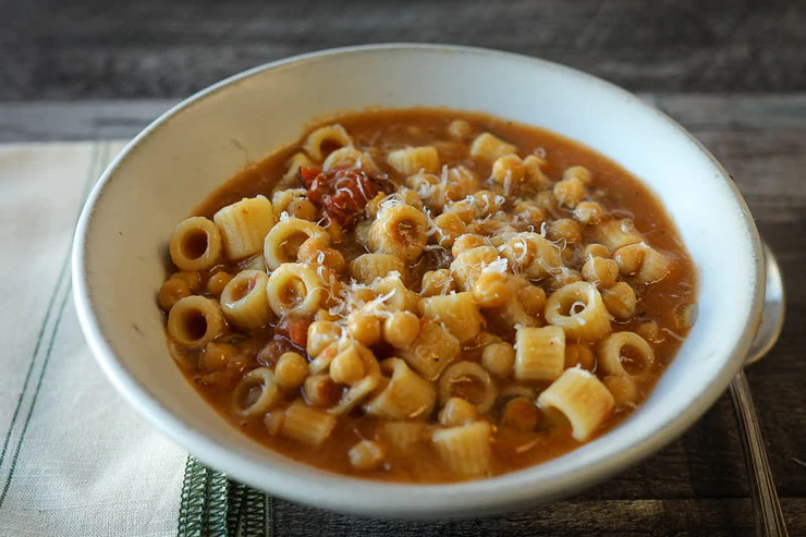 Soup of tubetti pasta and chickpeas in a serving bowl