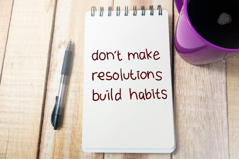 Notepad saying don't make resolutions, build habits