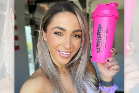 Janae Smith holding a neon pink nutrishop bottle