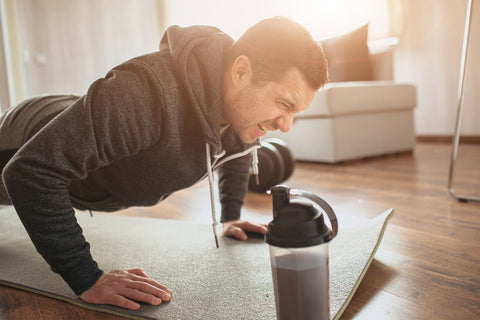 Man struggling while doing push ups