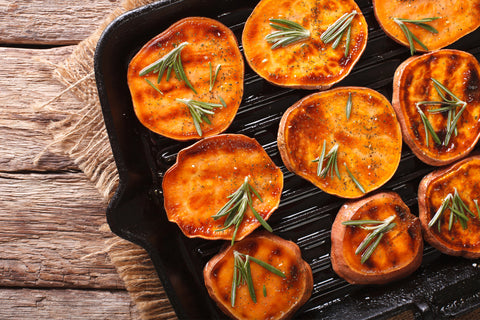 Grilled sweet potato slices topped with rosemary