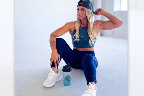 Tine Moore sitting with a nutrishop bottle