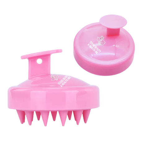 A pink Texas Beauty & Health Scalp Massager Shampoo Brush. This brush has a comfortable grip and delicate bristles, intended to provide a soothing scalp massage while shampooing.