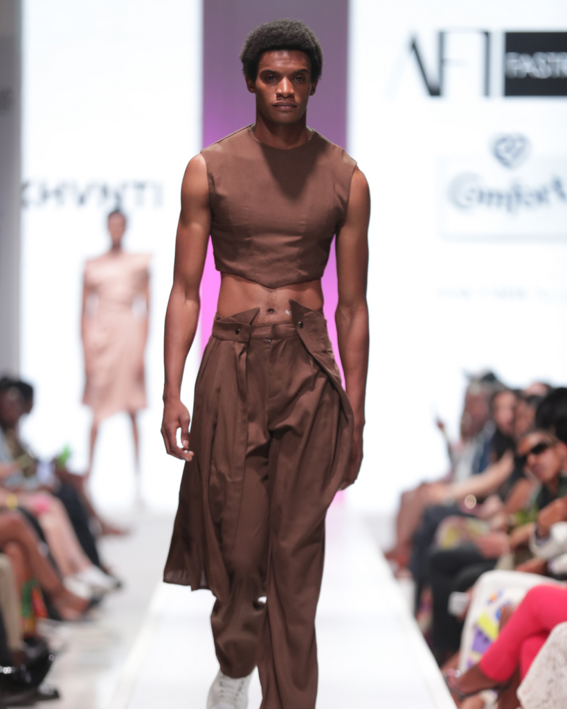 This torso-bearing, mud-brown crop top was paired with wide-legged pants, with a detachable overskirt.