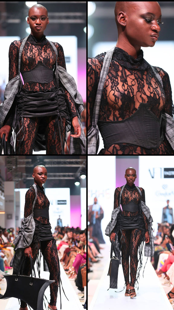 A lace bodysuit covers the body from neck to ankle. It forms the base for an under the bust corset and a matching mini skirt and a ruching detail, adjustable by drawstring. Draped over the shoulders is a grey plaid outerwear piece, ruched sporadically to produce an irregular, quilted effect.