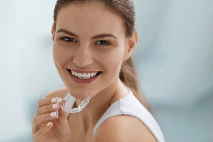 A girl shows her straight teeth without braces
