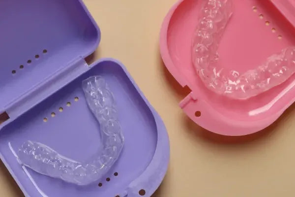 Two clear aligners in their colorful cases