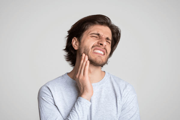 Man feeling pain in the jaw