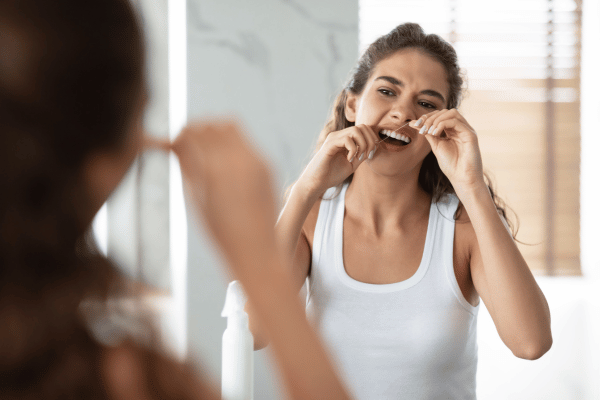 flossing teeth with tooth floss