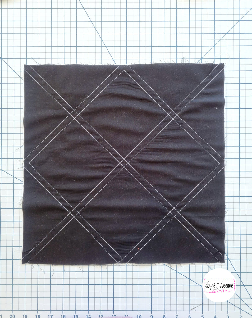 Black fabric piece showing stitched lines