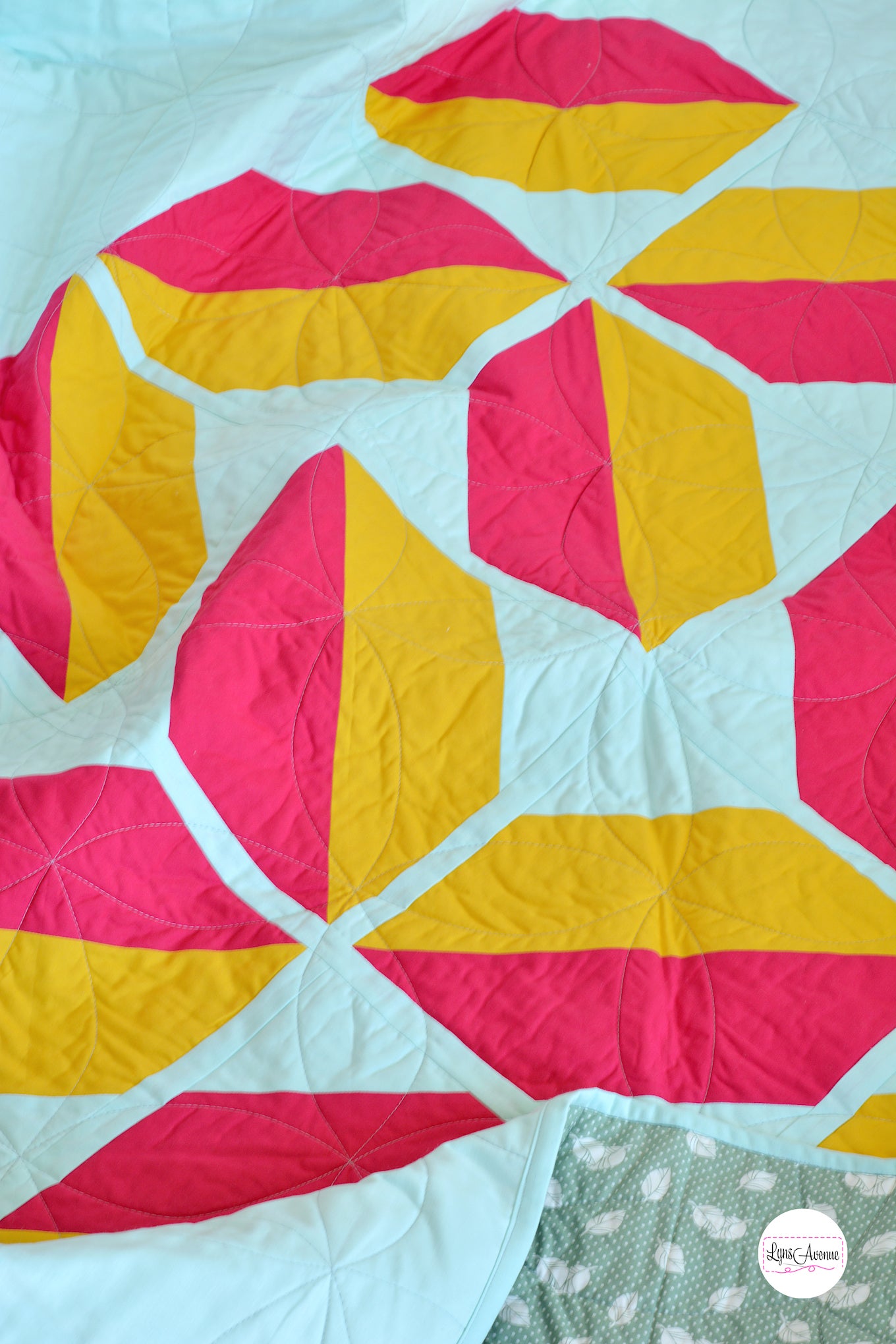 Red and Yellow flourishing quilt pattern on a mint background