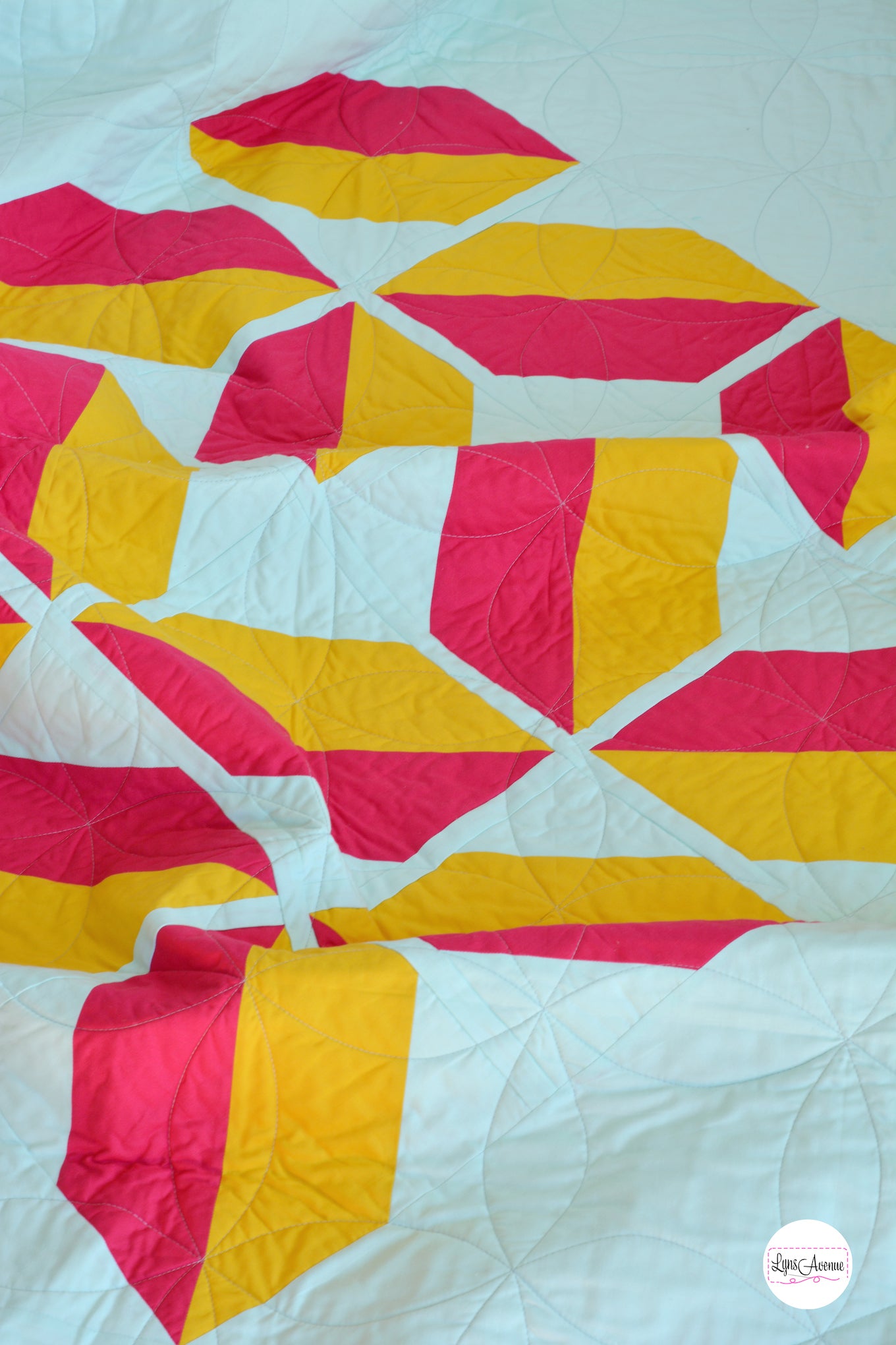 Red and Yellow flourishing quilt pattern on a mint background