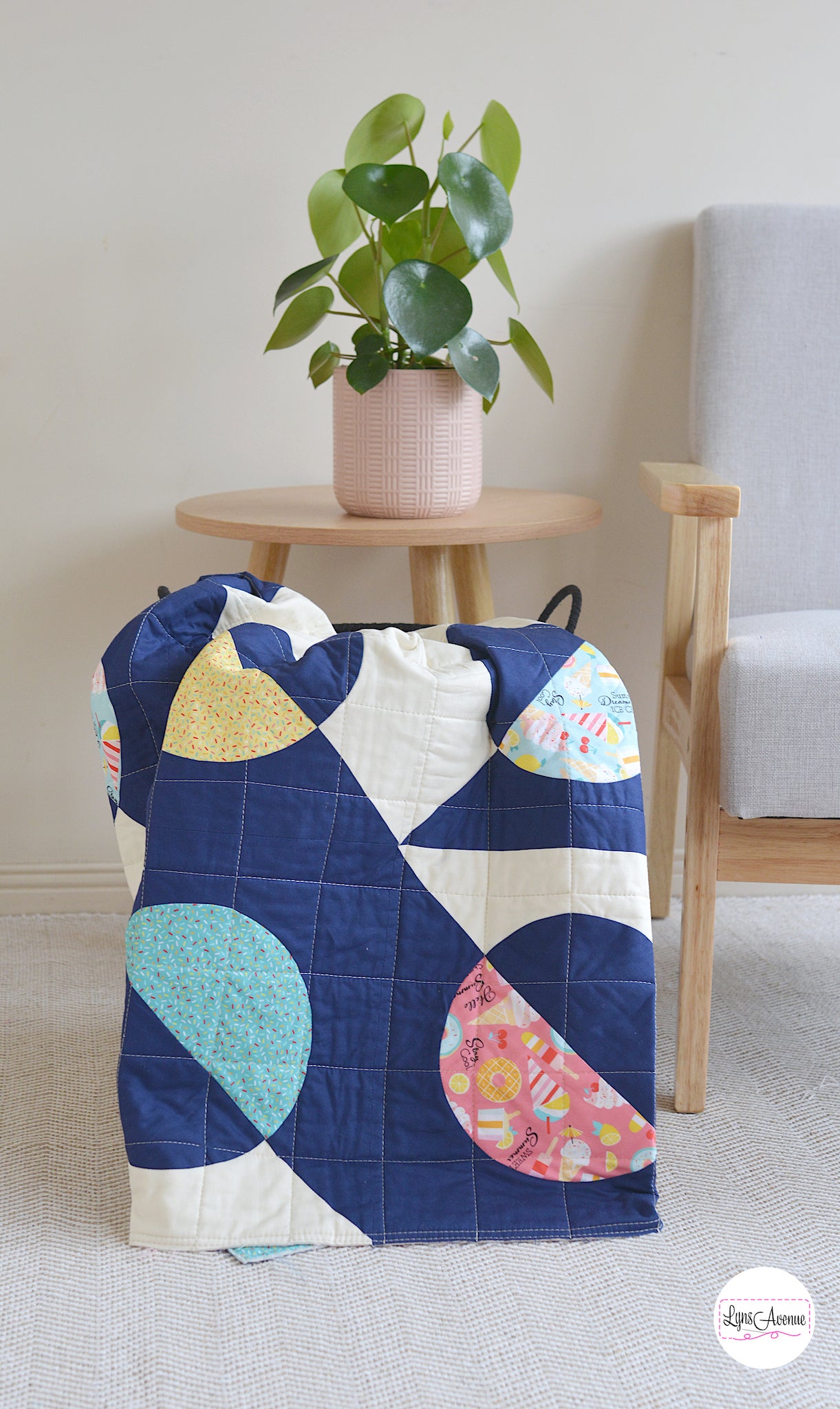 Hook and Pop quilt in navy blue and cream background with pops of colour in yellow, pink, green fabrics with sprinkles and ice cream designs