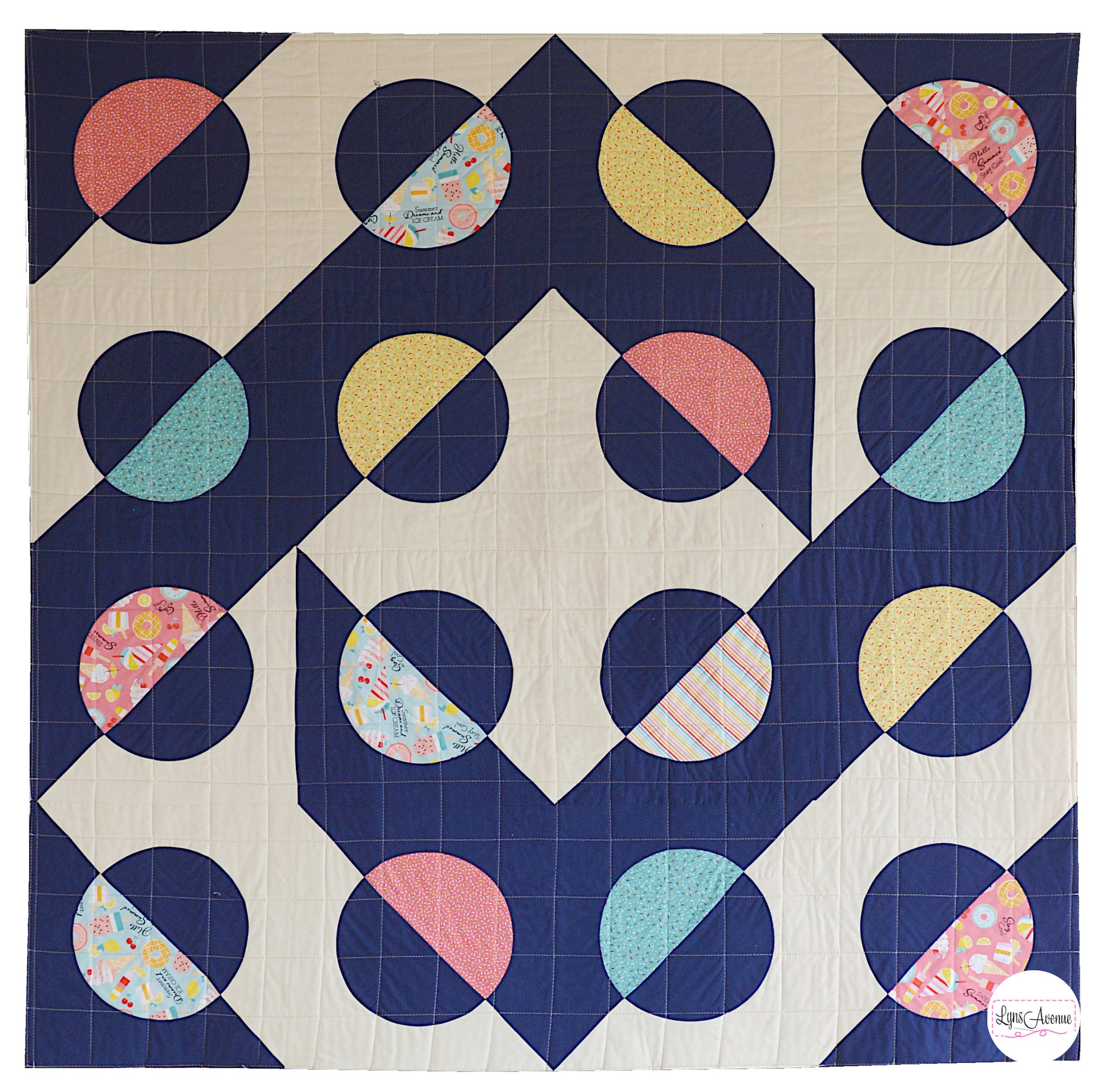 Hook and Pop quilt in navy blue and cream background with pops of colour in yellow, pink, green fabrics with sprinkles and ice cream designs