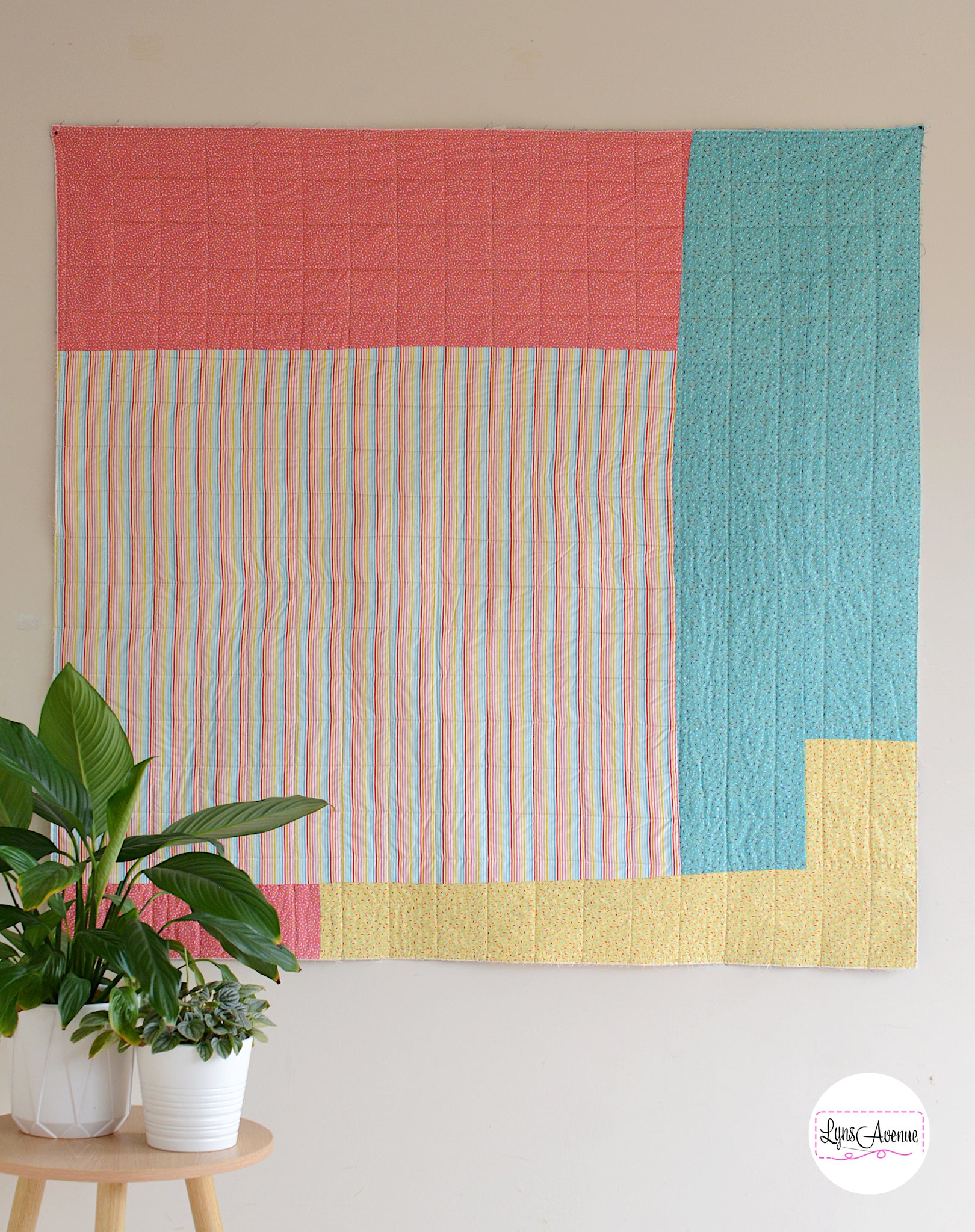 Hook and Pop quilt back in colourful striped and sprinkle fabric in yellow, pink, green colours