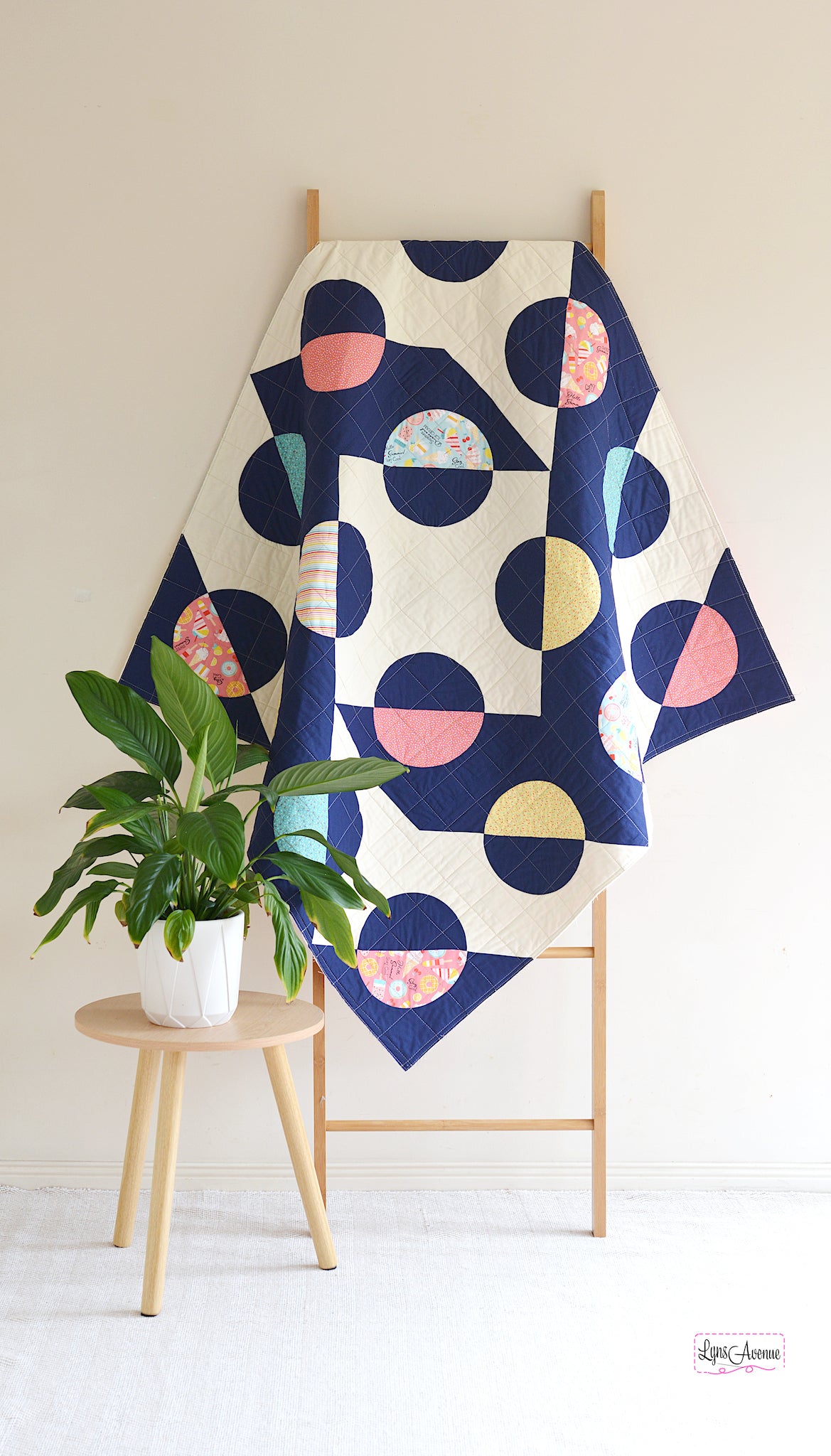 Hook and Pop quilt in navy blue and cream background with pops of colour in yellow, pink, green fabrics with sprinkles and ice cream designs