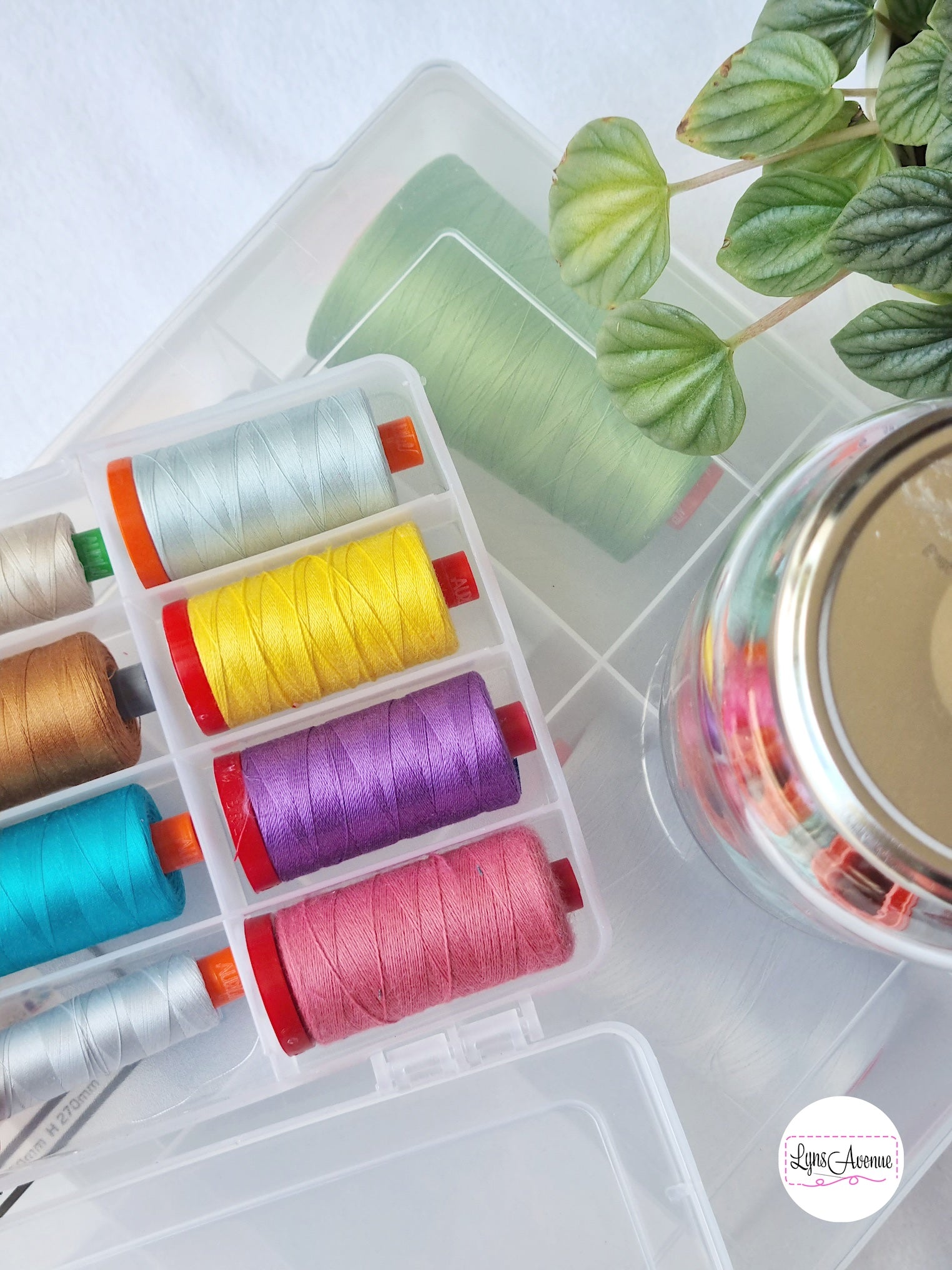 Image of plastic storage container with dividers showing spools of Aurifil threads in different colours