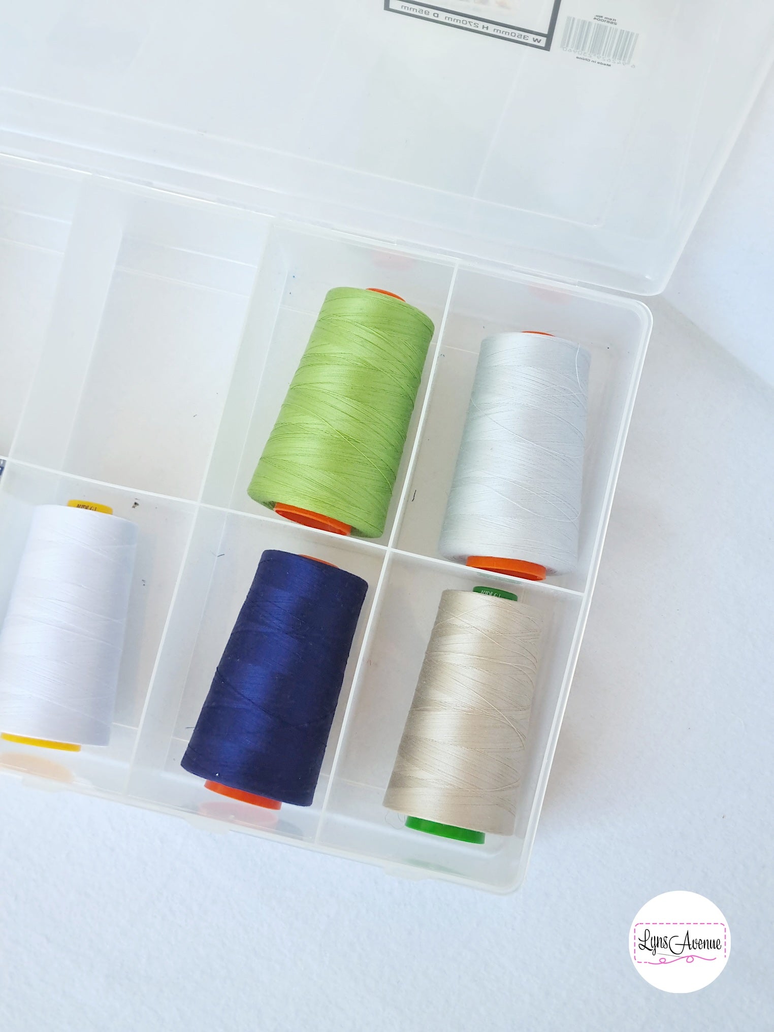 Image of large spool storage container with large spools of aurifil threads in different colours