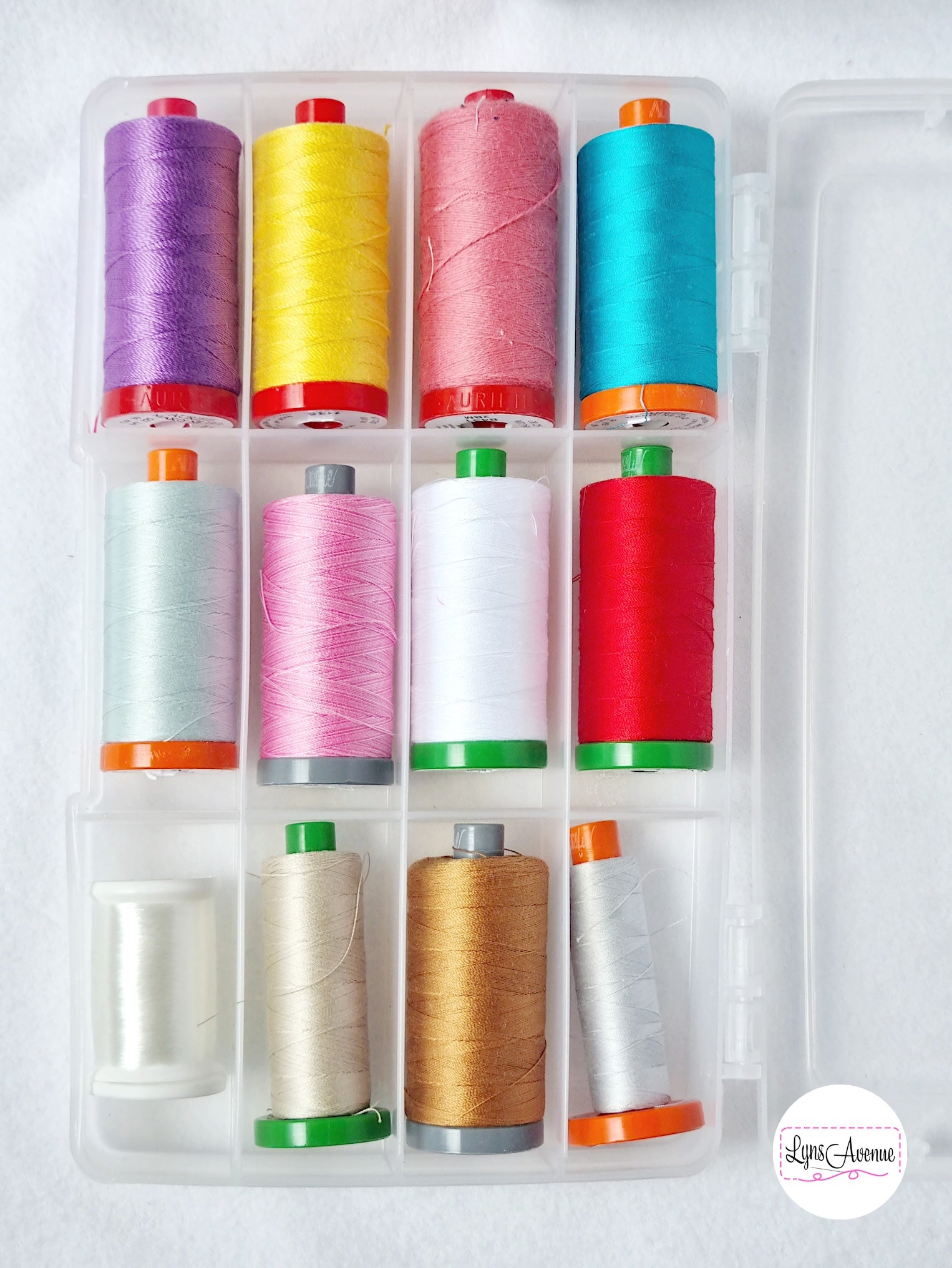 Image of plastic storage container with dividers showing spools of Aurifil threads in different colours