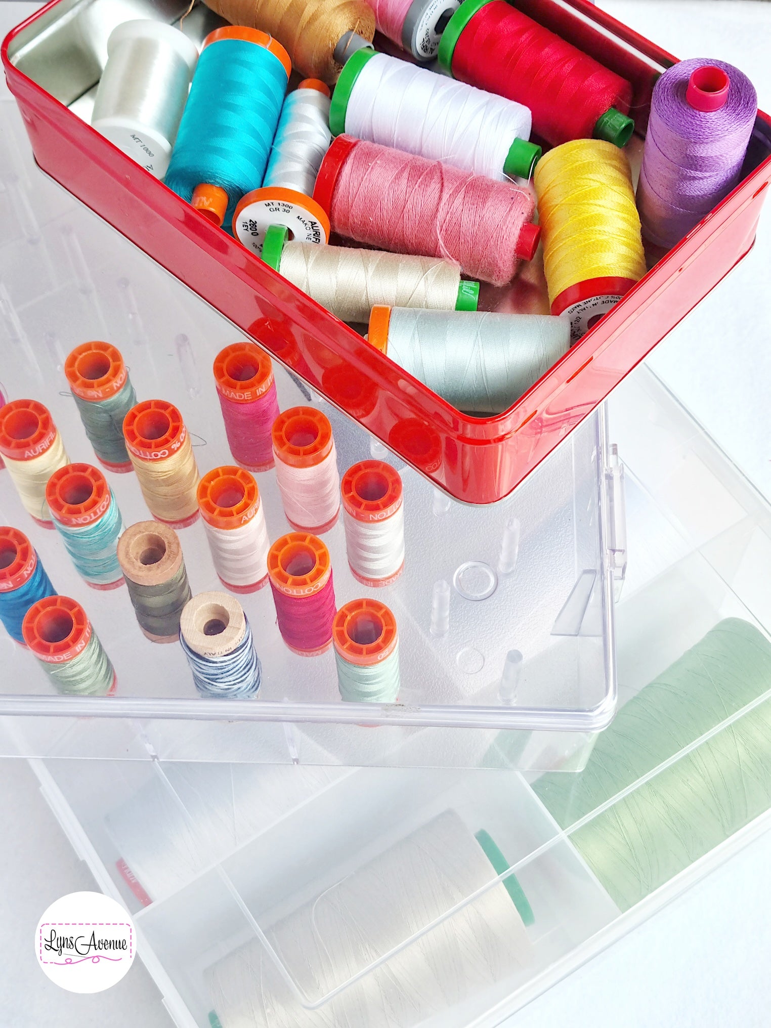 Image of plastic and tin storage container showing spools of Aurifil threads in different colours