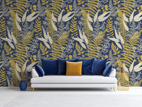 navy and gold large leaves wallpaper mural in living room with white sofa and navy and gold cushions