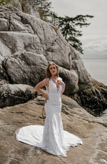 Pacific NorthWest bride wearing comfortable fitted lace wedding dress while standing on rock.