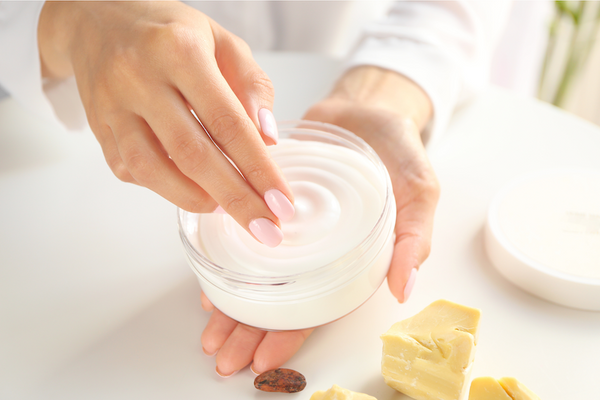 woman applying lotion to her skin