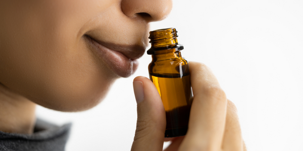 Woman smelling aroma from essential oils