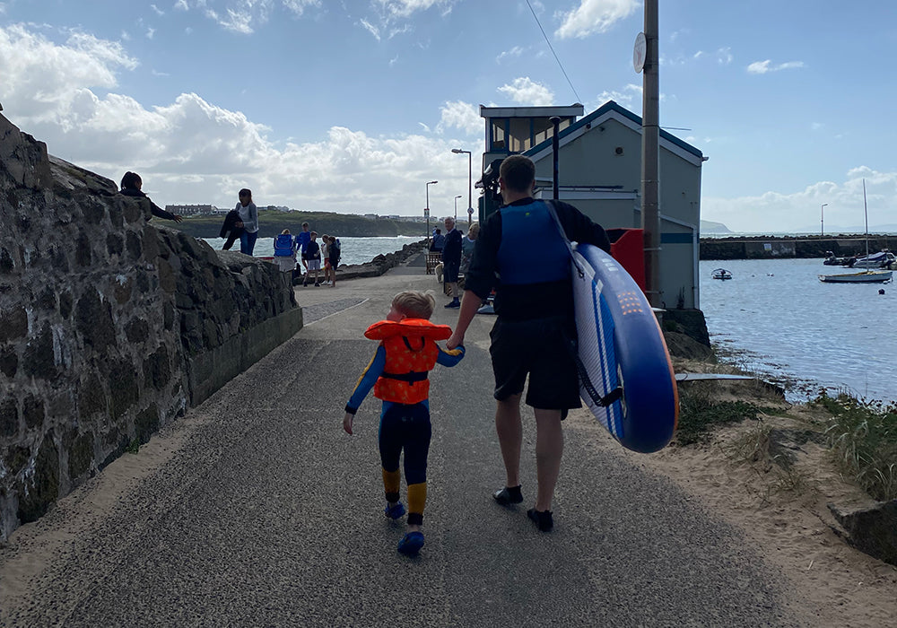 A father and son heading down to the water with an Aquaplanet MAX