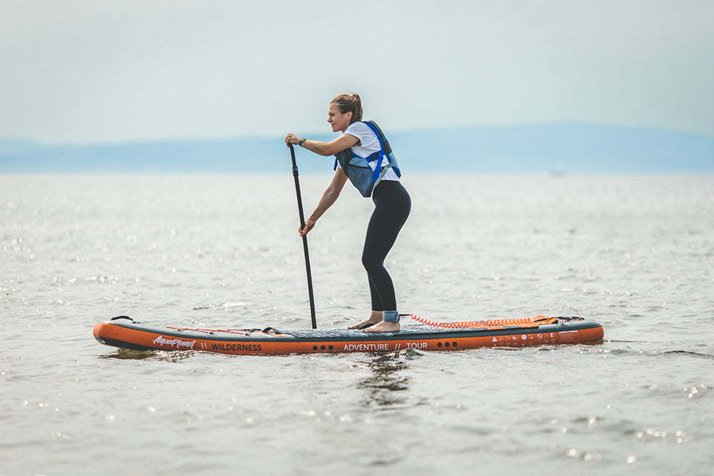 A person paddling on an Aquaplanet Wilderness paddle board