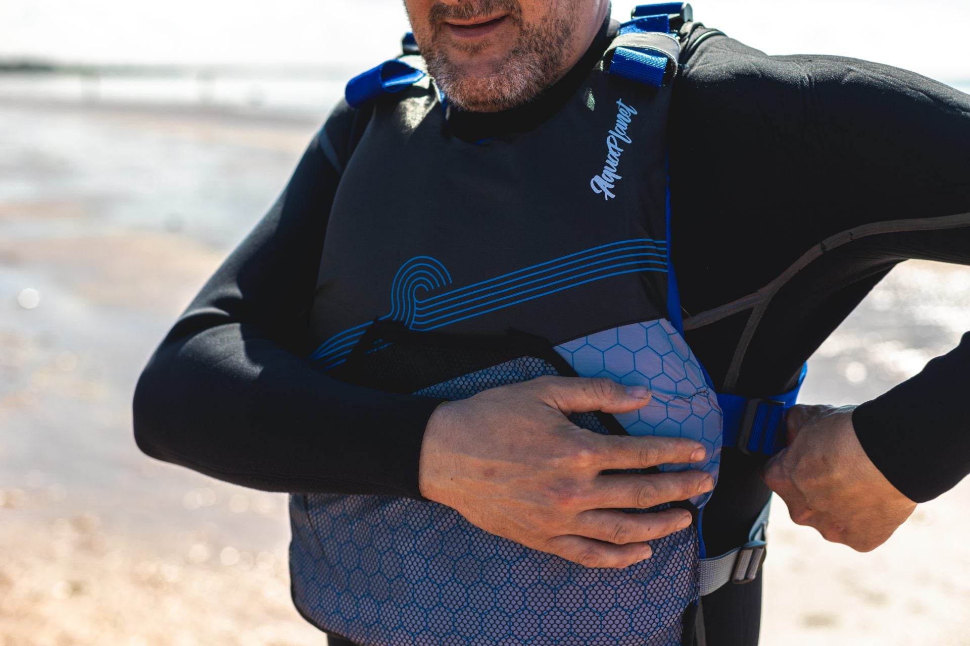 A person adjusting the Aquaplanet buoyancy aid to fit well