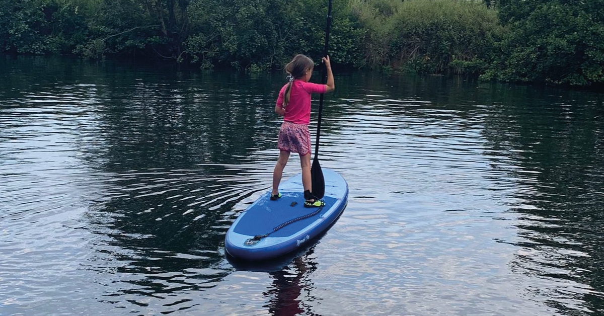 A girl on an Aquaplanet Allround Ten Paddle Board