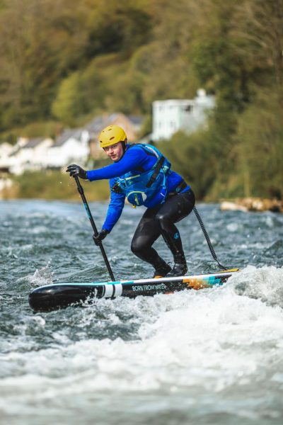 A person doing some white water paddle boarding on a Hurley Advantage Outsider paddle board