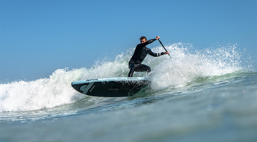 a man SUP surfing on the Aquaplanet Wingtail