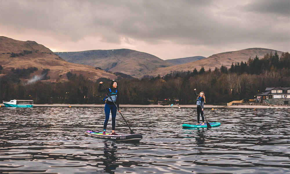 two women on an aquaplanet PACE and MAX paddle boards