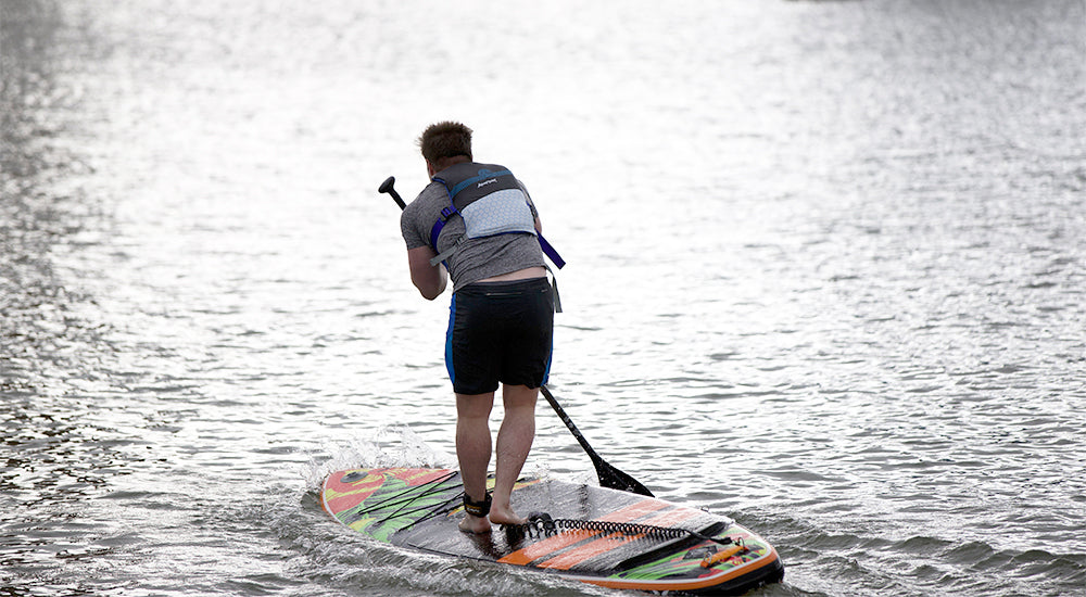 someone about to fall off of an Aquaplanet paddle board
