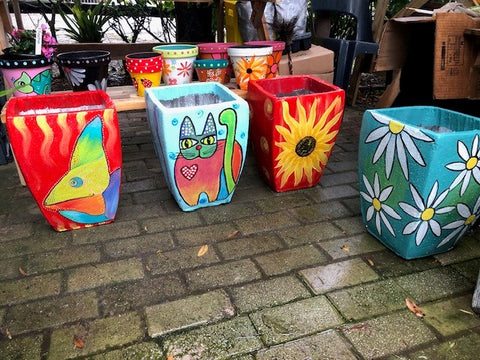 hand painted concrete pots by Tina Deall.