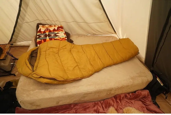 yellow-sleeping-bag-in-a-tent