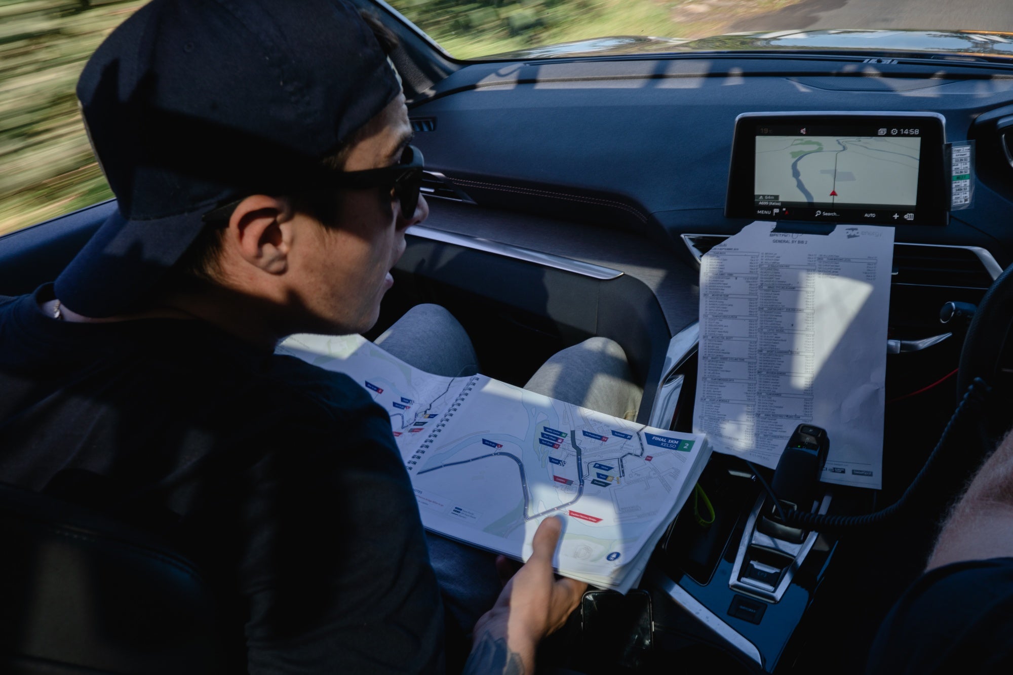 Team member in the car looking at gps