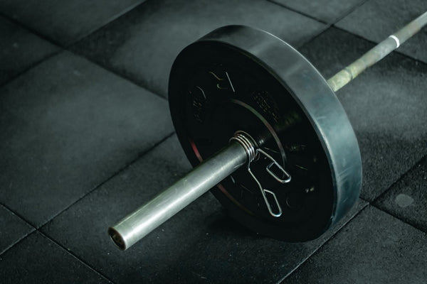 close up image of standard barbell with weight plates