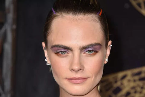 Actress Cara Delevingne with a helix piercing on her ear.
